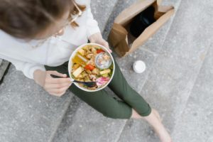 a person easting food on steps 