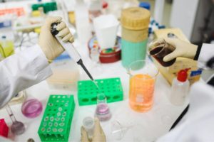 A person holding a pipette of possible forever chemicals Photo by Polina Tankilevitch: https://www.pexels.com/photo/scientists-in-laboratory-3735780/