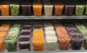 A display of vegetables in plastic containers