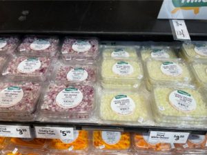 A shelf with plastic containers of food