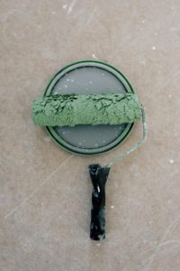 A roller with green paint on it