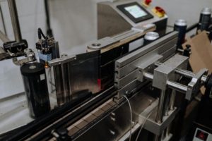 an automated machine. Photo by cottonbro studio: https://www.pexels.com/photo/automated-machineries-in-a-brewery-assembly-line-5532711/
