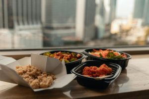 plastic black-bottom takeout containers Photo by Jacoby Clarke: https://www.pexels.com/photo/close-up-photo-of-food-on-wooden-table-3757086/