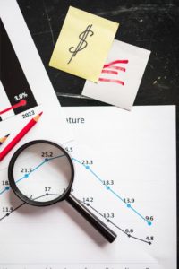 a magnifying glass and a graph