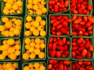 A group of containers of tomatoes Photo by Deane Bayas: https://www.pexels.com/photo/abundance-of-yellow-and-red-tomatoes-at-the-market-17804807/