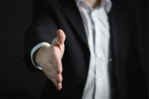 a man reaching out to shake your hand
