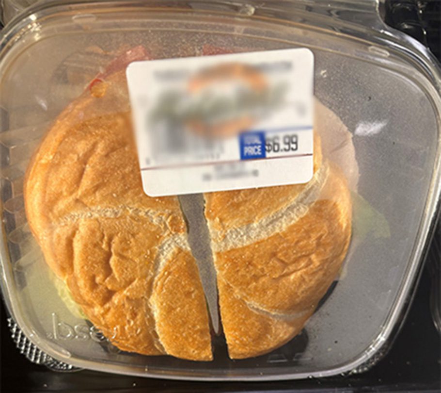 a sandwich in a plastic food package with condensation