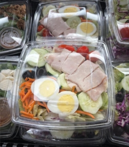 a salad in a plastic food package 