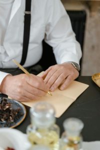 someone recording data Photo by MART PRODUCTION: https://www.pexels.com/photo/person-in-white-dress-shirt-holding-brown-chopsticks-8450474/