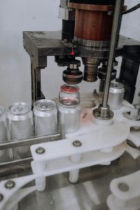 a machine in a factory. Photo by cottonbro studio from Pexels: https://www.pexels.com/photo/automated-machineries-in-a-brewery-assembly-line-5532711/