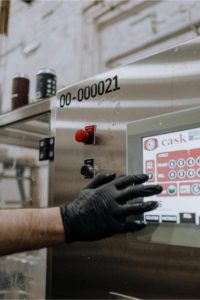a person prgramming a machine. Photo by cottonbro studio: https://www.pexels.com/photo/person-with-black-gloves-in-hand-holding-a-machine-5532835/