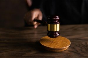 a court gavel Photo by KATRIN BOLOVTSOVA: https://www.pexels.com/photo/brown-wooden-gavel-on-brown-wooden-table-6077326/