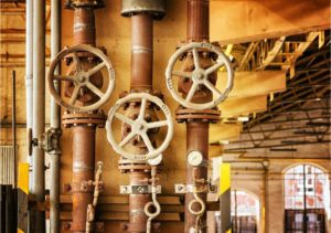 The inside of a factory Photo by Pixabay: https://www.pexels.com/photo/ageing-plant-357440/