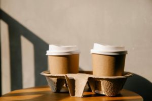 compostable cups. Photo by Sarah Chai: https://www.pexels.com/photo/cardboard-cups-on-holder-tray-on-table-7262475/ sustainable packaging