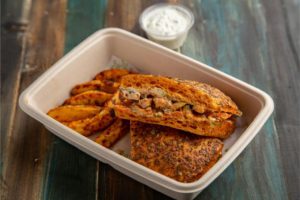 food in a molded fiber package. Photo by Amit Fulwaria: https://www.pexels.com/photo/close-up-of-a-sandwich-and-fries-in-a-box-20115301/