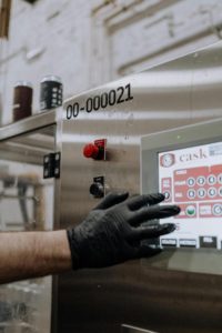 someone programming a machine. Photo by cottonbro studio: https://www.pexels.com/photo/person-with-black-gloves-in-hand-holding-a-machine-5532835/