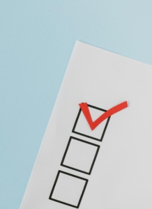 a checklist. Photo by Tara Winstead: https://www.pexels.com/photo/red-check-mark-on-box-in-close-up-view-8850709/