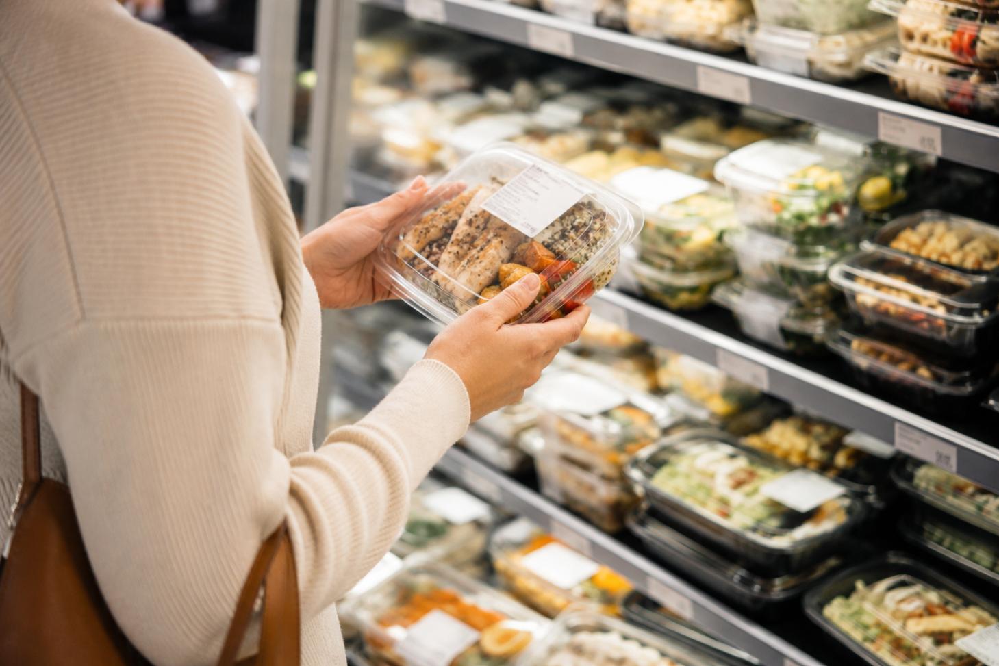 someone examining the size of an pre-packaged in-store meal
